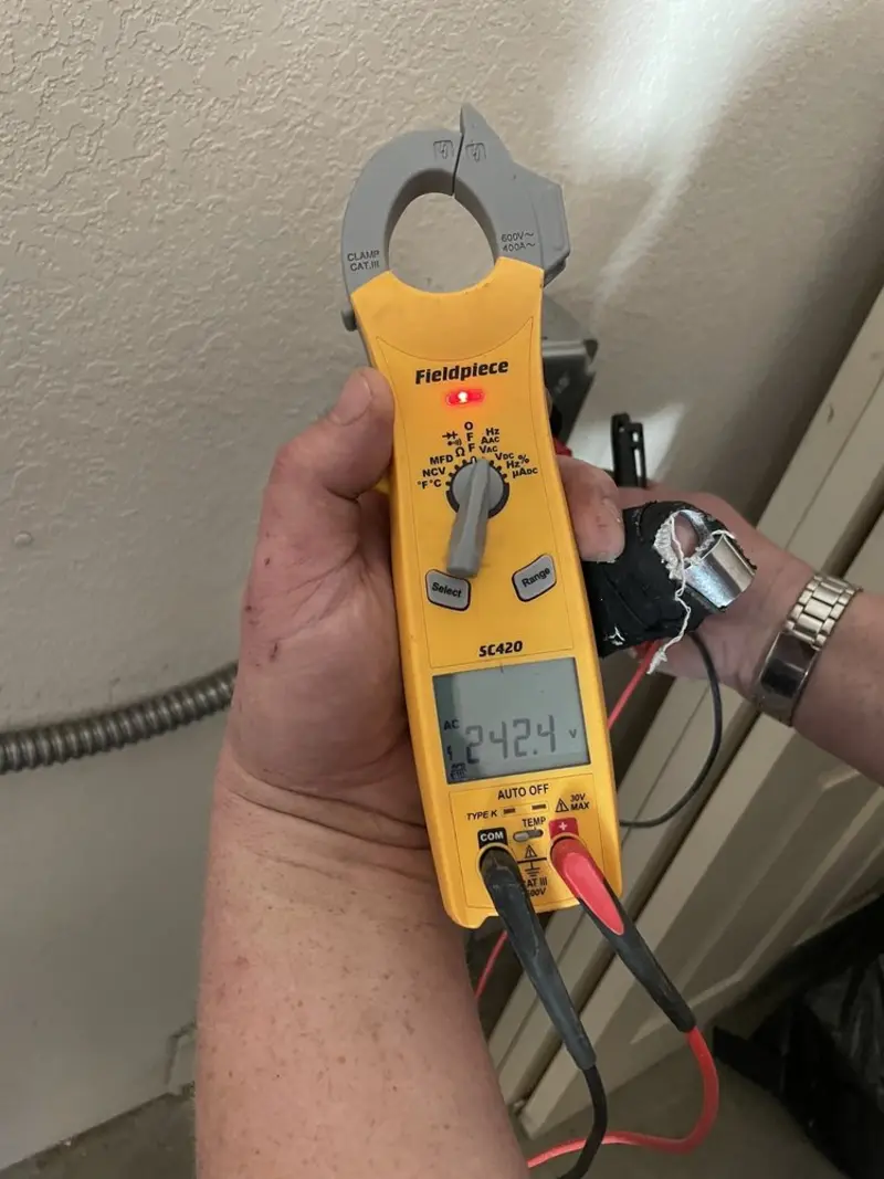 Voltage testing with clamp meter during Outlet Installation in Conklin